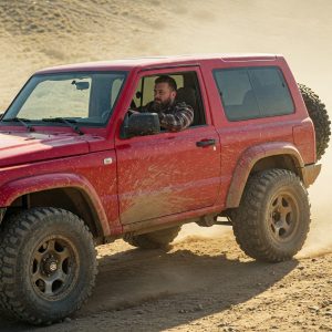 Red SUV dad with rugged vehicle off-road driving adventure