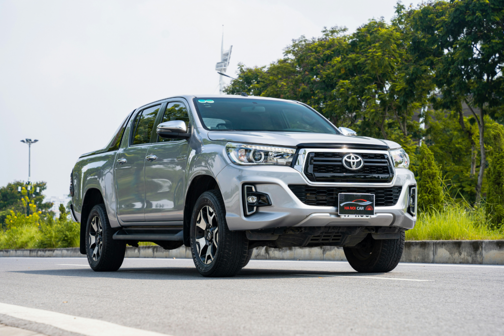 White Toyota Hilux pickup truck displayed outdoors, representing popular JDM import vehicles sought by enthusiasts in U.S.