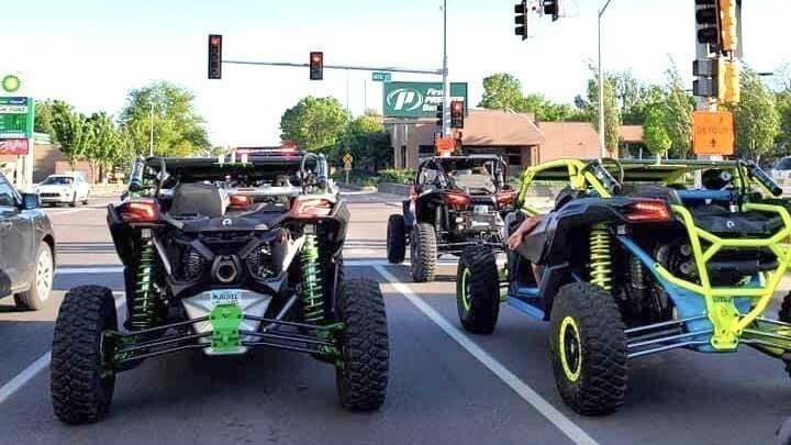 Custom off-road buggies and UTVs lined up on city street ready for spring trail adventures and outdoor exploration
