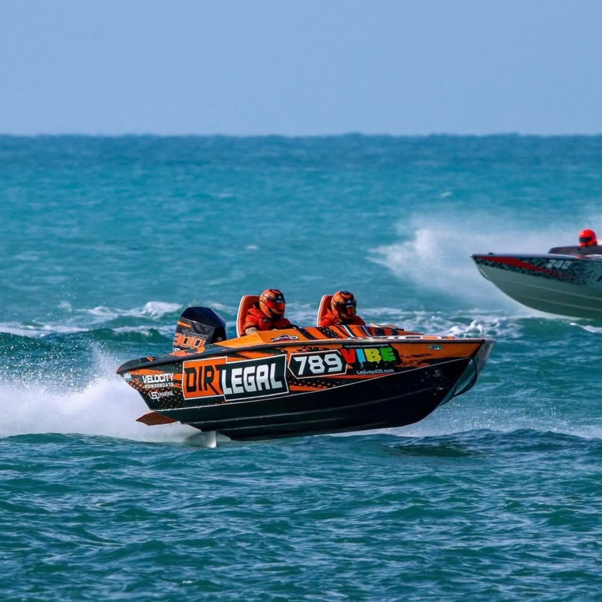 Dirt Legal's #789 Velocity Factory Team race boat running offshore alongside a competitor