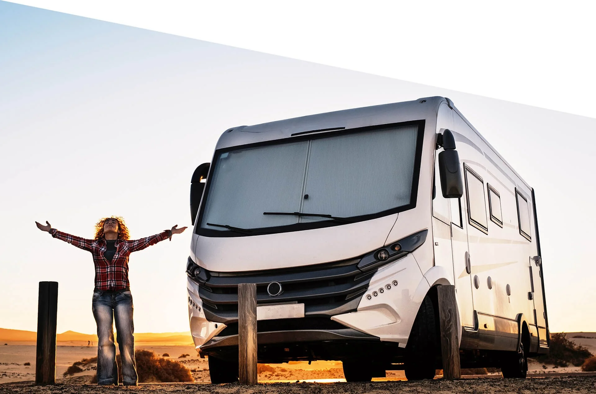 Woman standing outstretching arms and enjoying freedom in front of rv