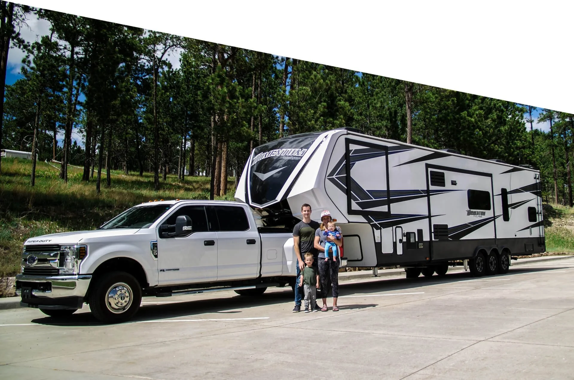 family of 4 standing in front of trailer