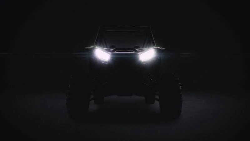 High-performance Kawasaki UTV illuminated headlights in darkness showcasing new mystery model design