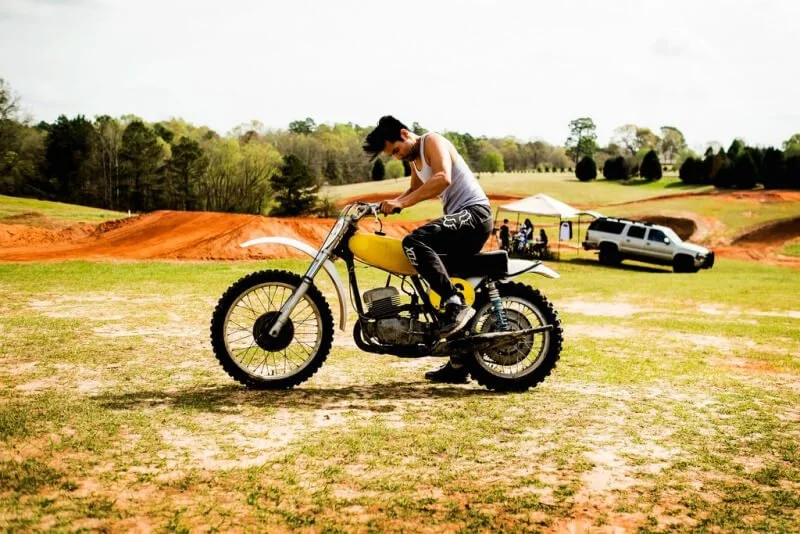 man riding vintage dirt bike