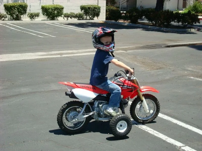 toddler on dirt bike with training wheels