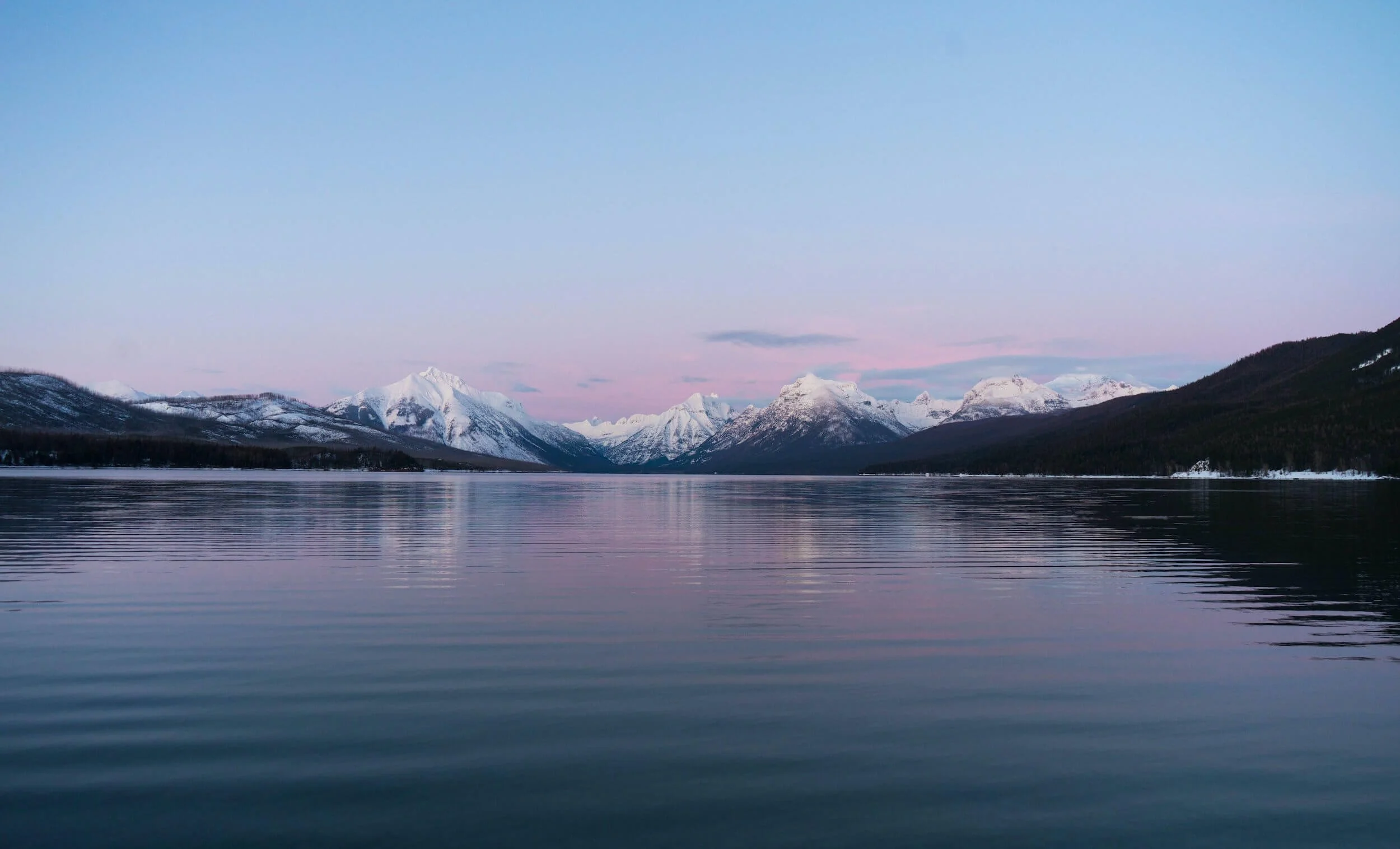 snow covered mountain near lake in Montana