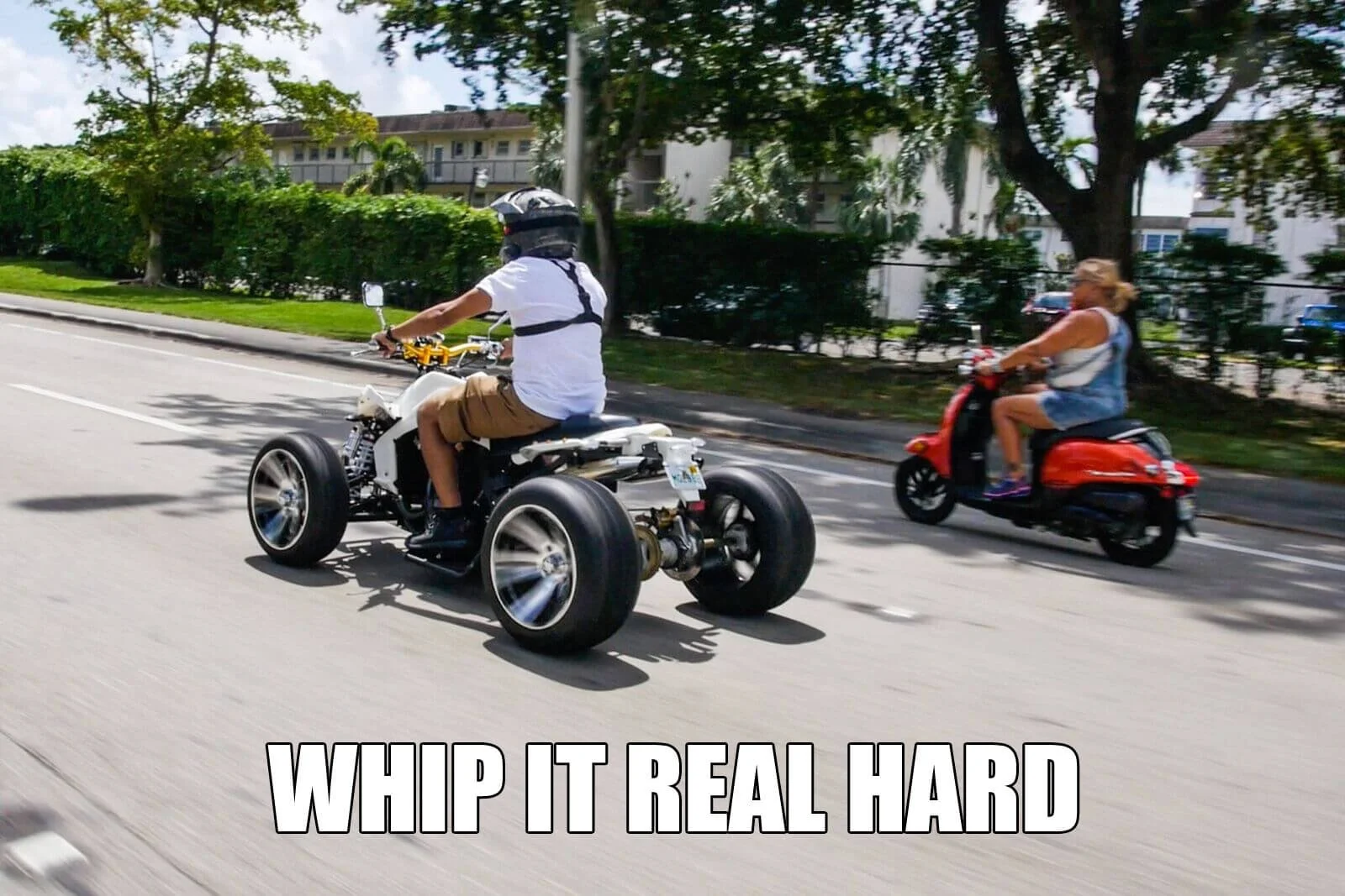 man riding atv on street