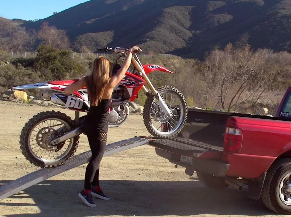 moving lightest dirt bike on the back of a car