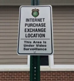 Sign that says Internet purchase exchange location - this area is under video surveillance
