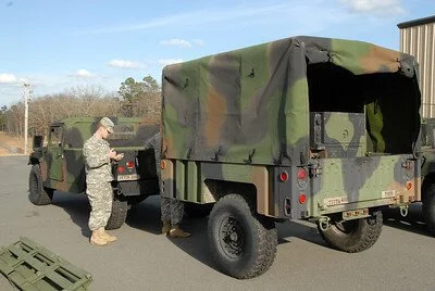 army person in front of military car