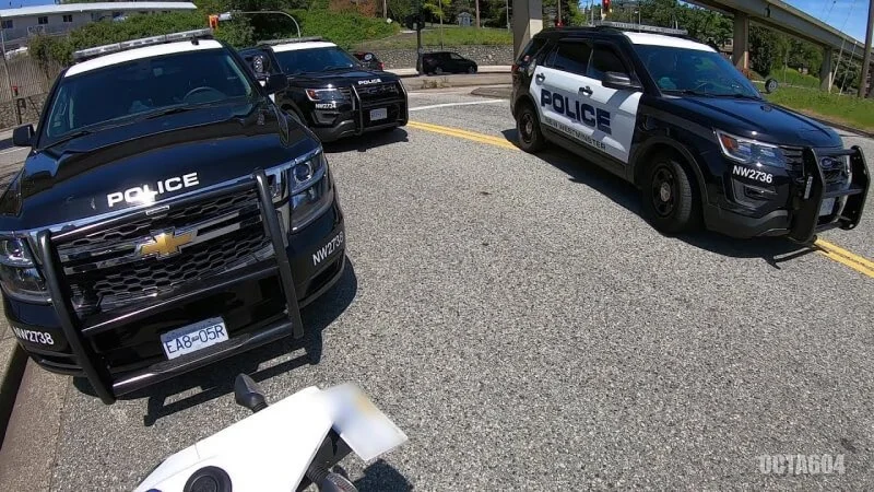 Police vehicles parked at crime scene during investigation of stolen dirt bike recovery operation
