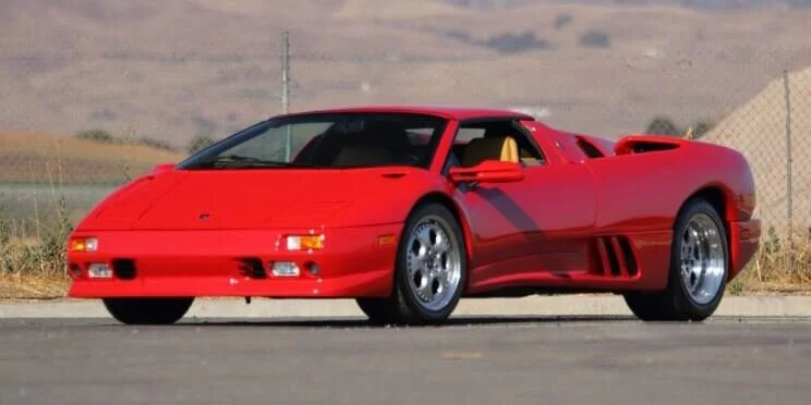 Red Lamborghini Countach sports car parked outdoors, example of exotic vehicle eligible for Show and Display Rule importation