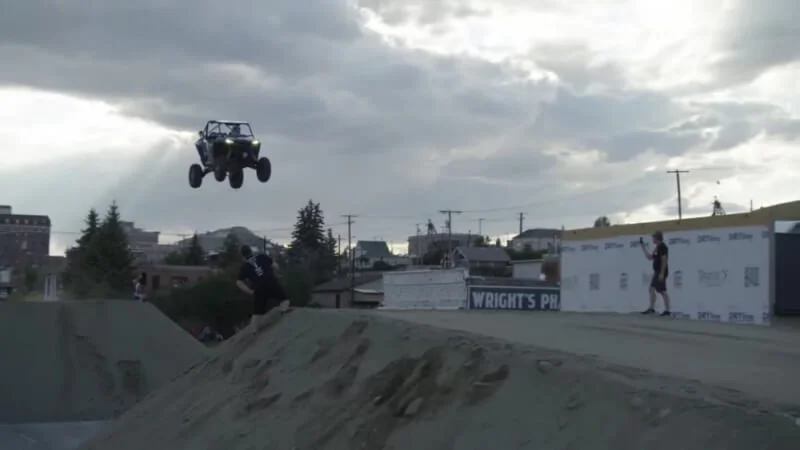 Tanner Godfrey airborne in UTV during record-breaking 247-foot jump attempt over dirt ramp