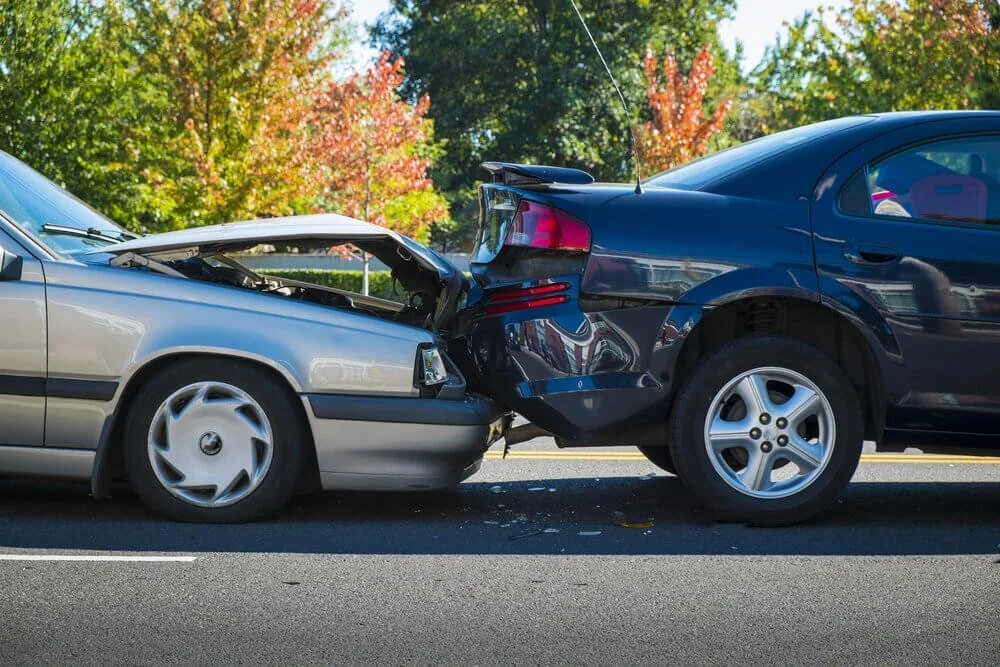 Two cars colliding in parking lot accident requiring insurance claim assessment and reporting