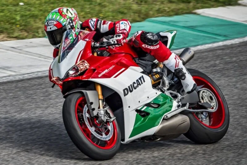 Ducati superbike in red, white and green racing on track at high speed, fastest motorcycles