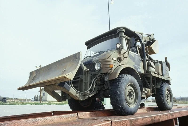 Military Unimog dump truck on display, showcasing rare American military vehicle for street legal conversion consideration.