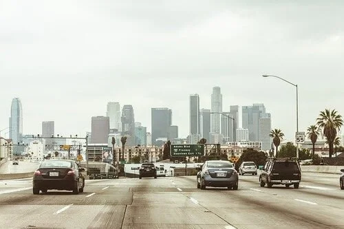 Los Angeles freeway traffic with downtown skyline, illustrating California vehicle regulations and emissions standards