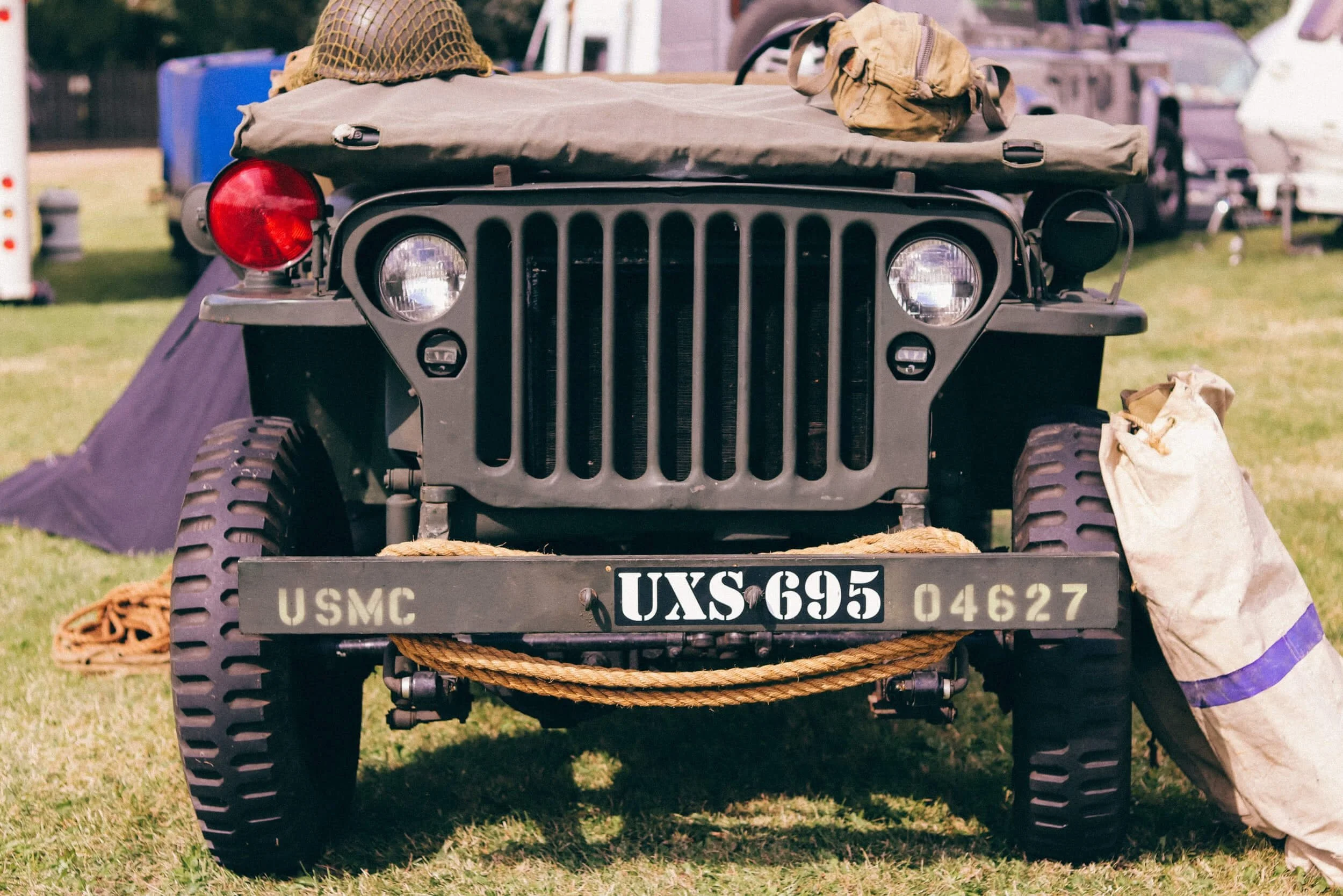 Vintage military Jeep with USMC markings displayed at outdoor show, representing classic road-legal utility vehicles