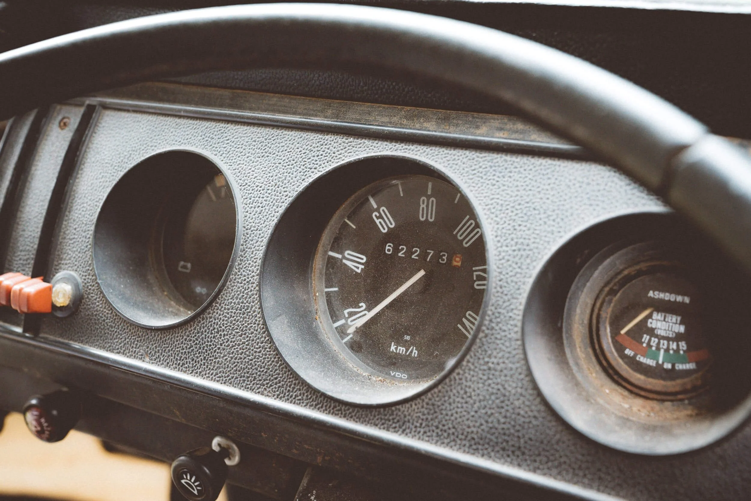 Vintage car speedometer showing 62273 kilometers with odometer displaying actual mileage on dashboard