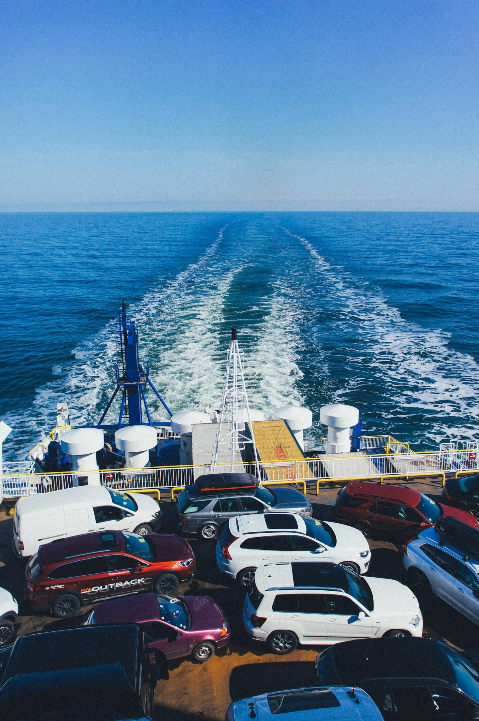 Cars parked on military transport ferry ship crossing ocean waters