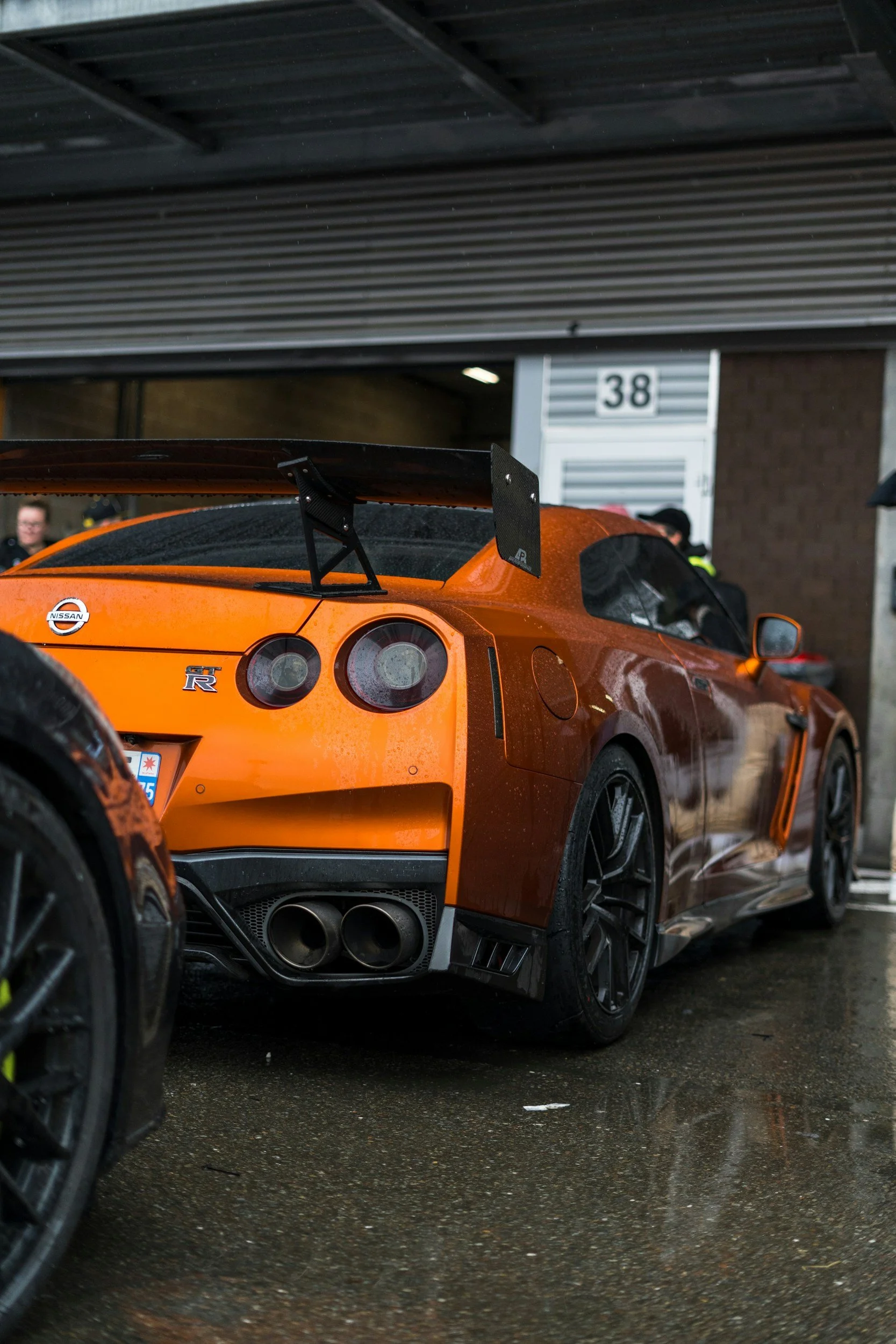 Bright orange Nissan GT-R sports car showcased in garage, exemplifying popular JDM classics gaining popularity among U.S.