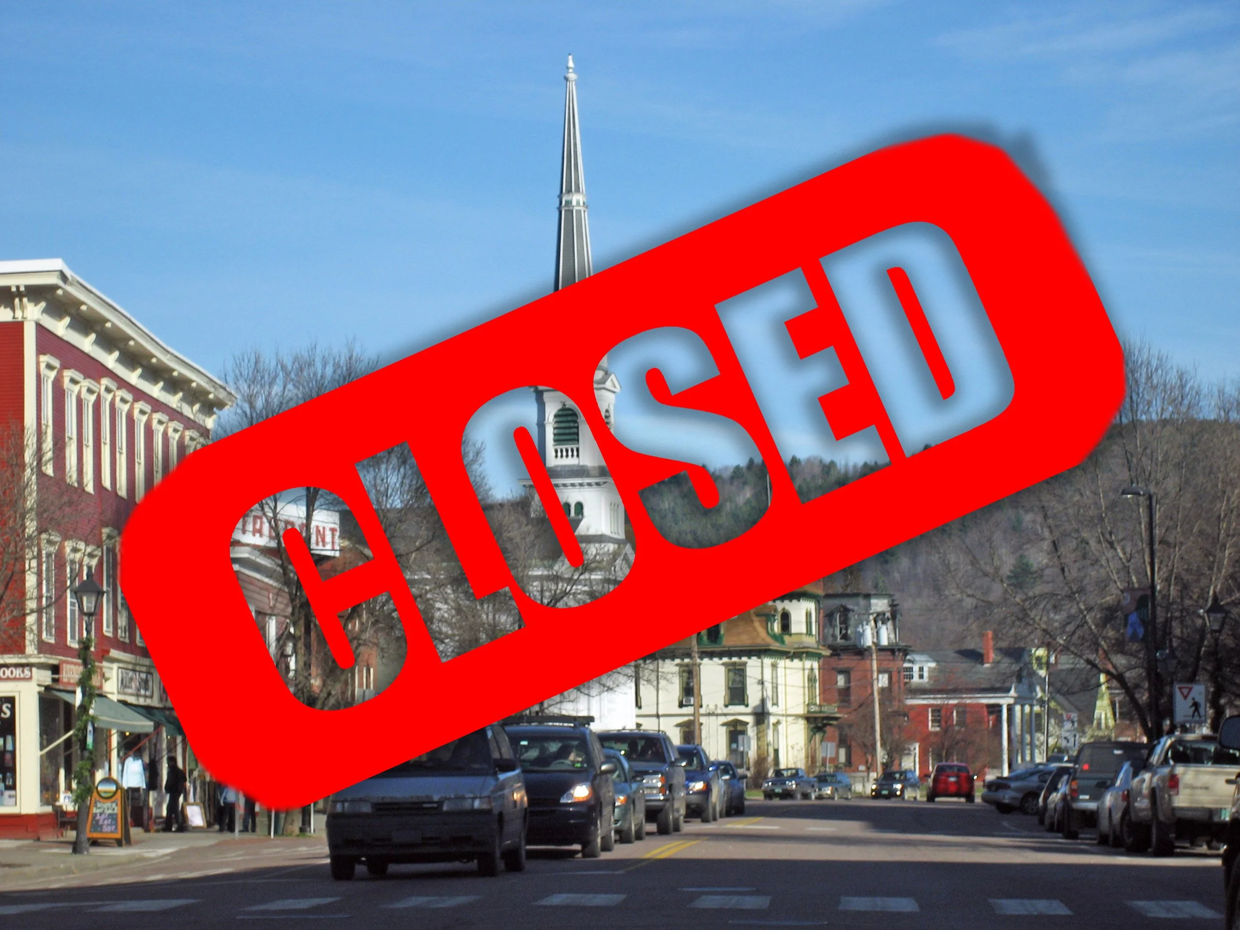 Vermont town street with historic buildings and parked cars marked with red CLOSED stamp overlay