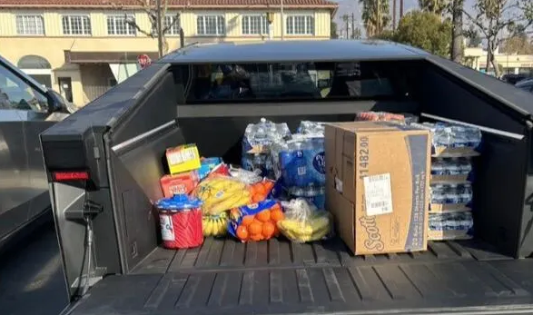 Cybertruck bed loaded with supplies and water bottles for Los Angeles wildfire relief efforts