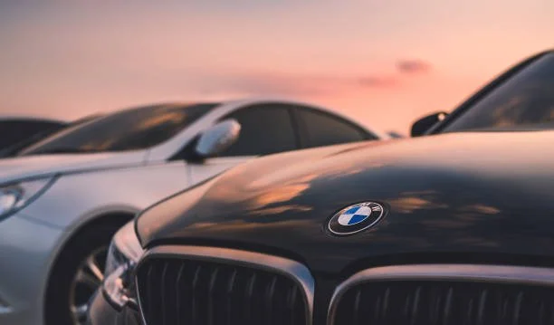 German elevated cars parked at sunset, representing automotive industry tariff concerns and trade policy impact on carmakers