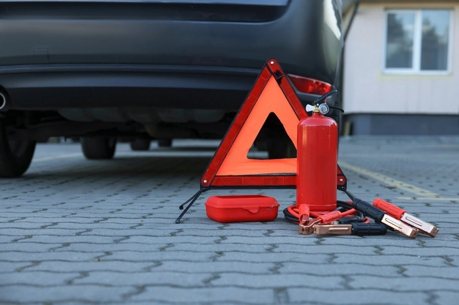 Emergency car kit with warning triangle, fire extinguisher, jumper cables