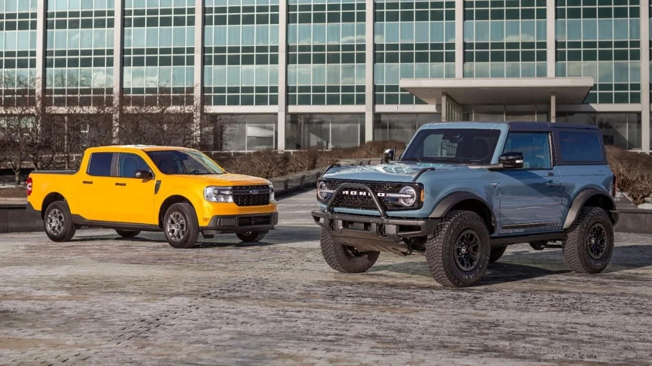 Yellow Ford Maverick and blue Ford Bronco Sport parked side by side during recall announcement for battery failure risks
