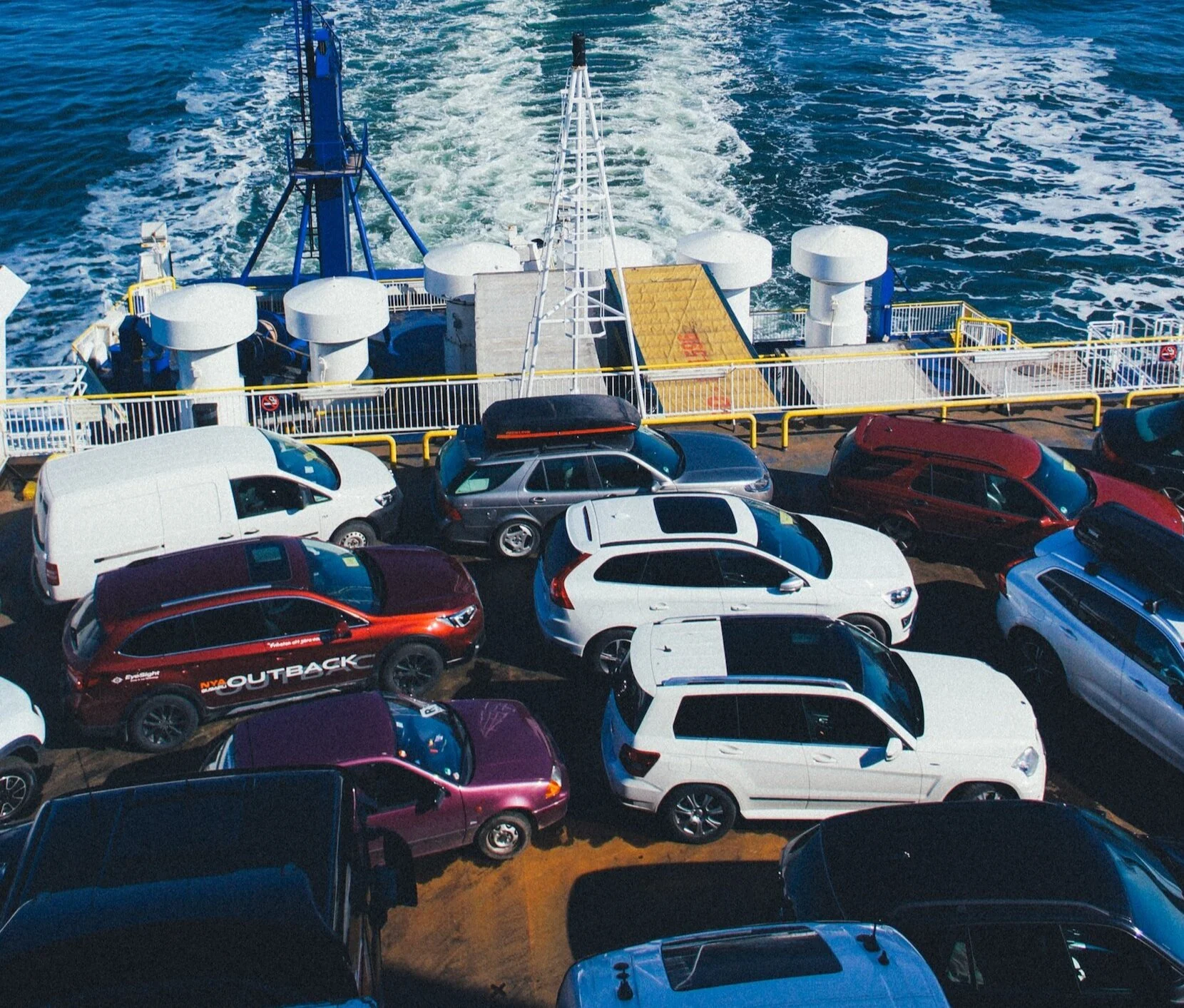 Multiple cars parked on ferry deck illustrating vehicle purchasing risks and potential cloning fraud concerns