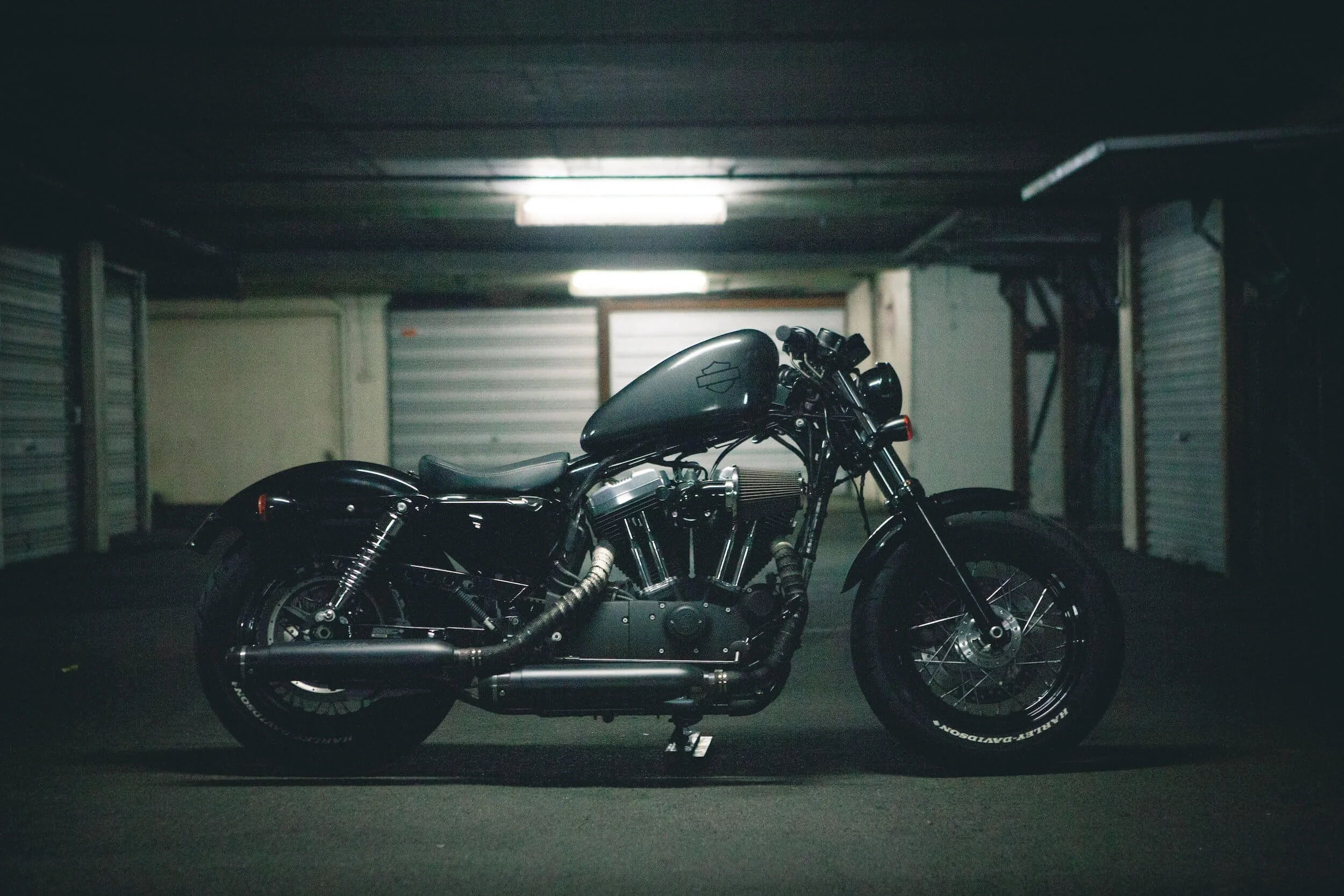 Black motorcycle parked in garage, symbolizing motorcycle ownership and the importance of maintaining vehicle titles