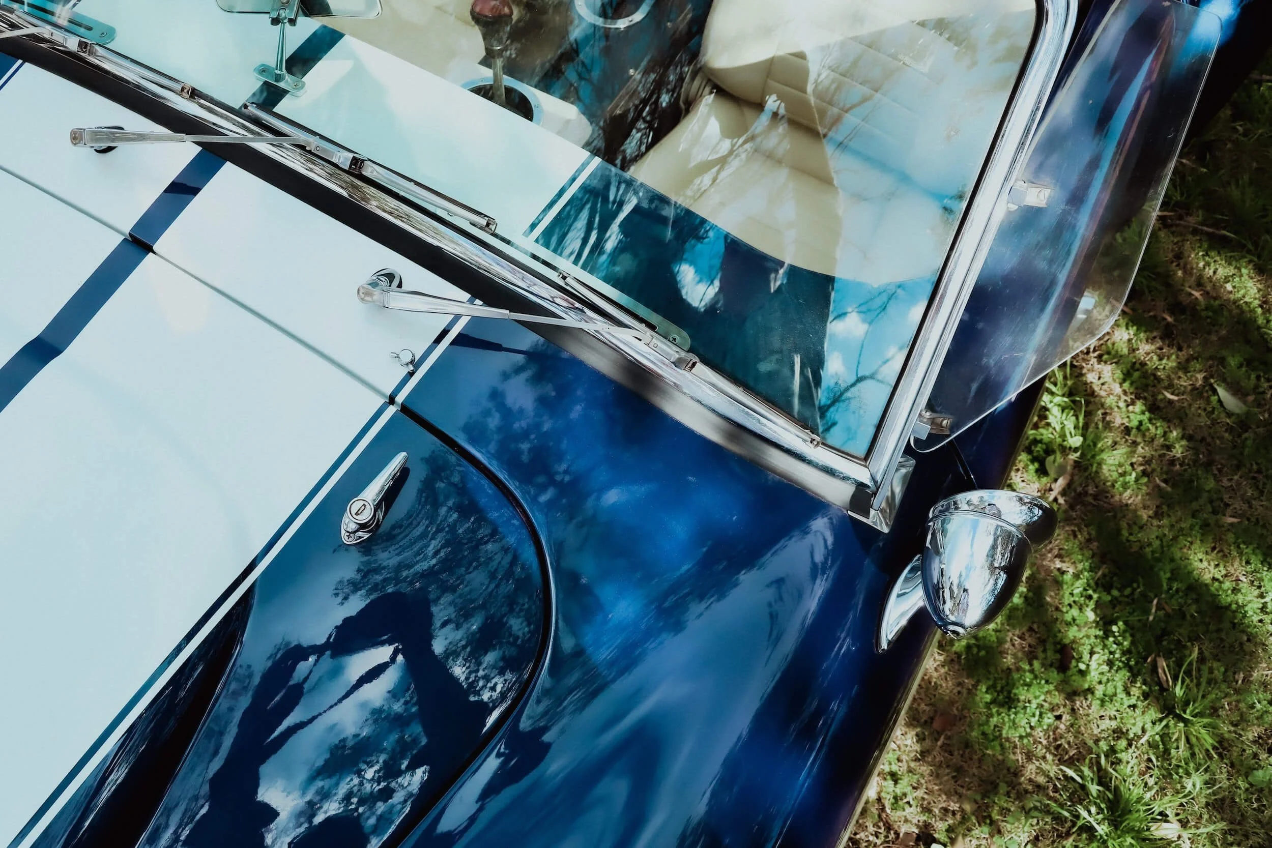 Vintage blue and white kit car with custom bodywork parked outdoors