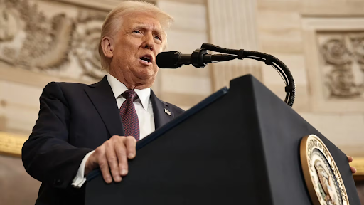 Man speaking at presidential podium about tariff policies affecting North American auto production and supply chains