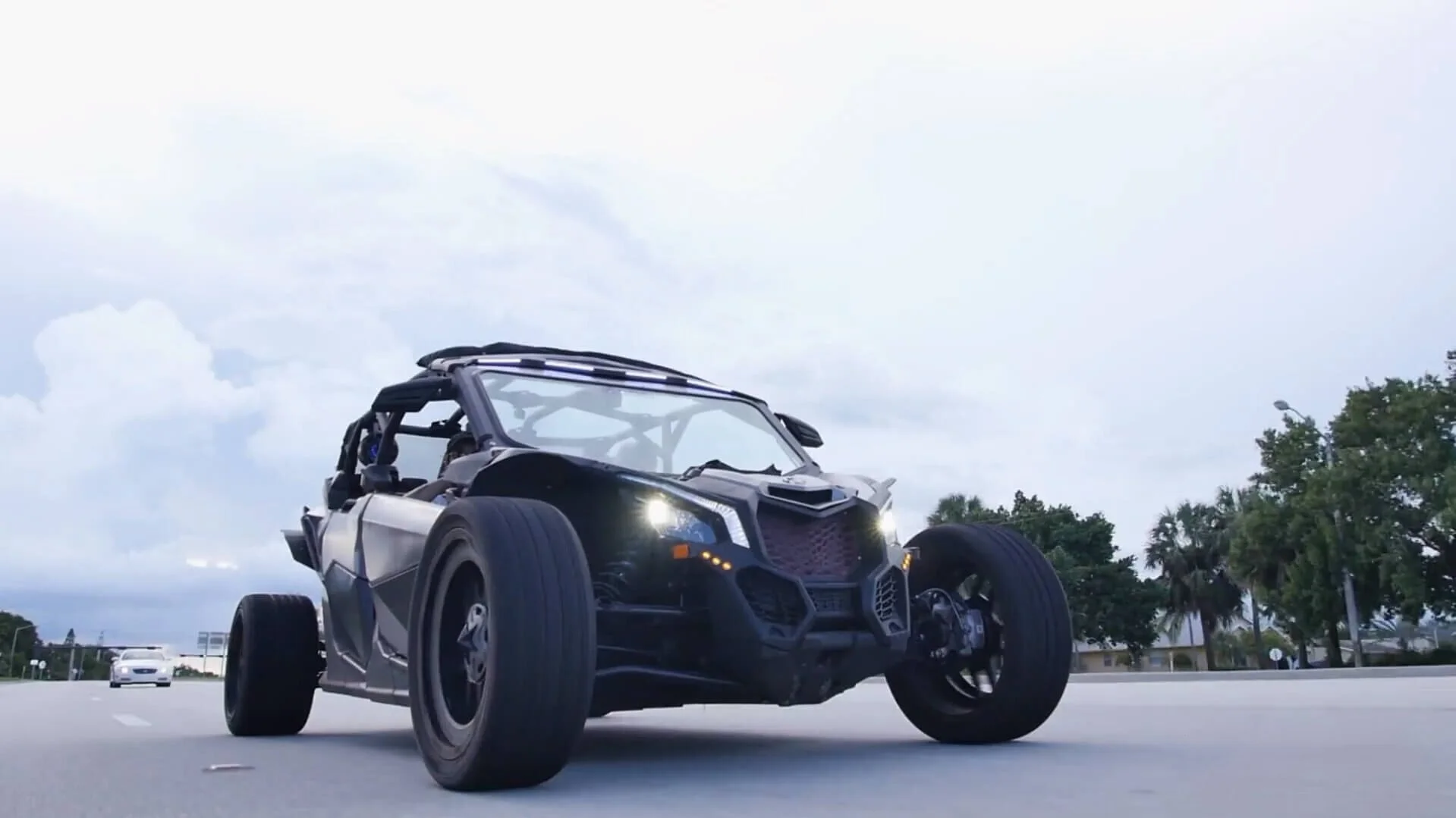 Black custom off-road buggy on street with roll cage and large tires ready for street legal conversion