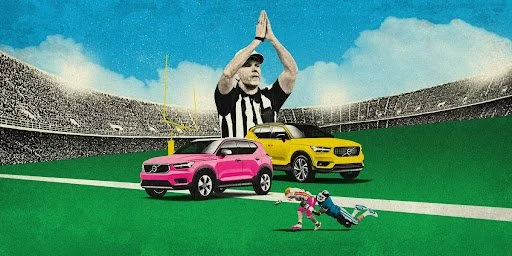 Colorful SUVs on football field with referee, illustrating Super Bowl automotive advertising campaigns and car brand