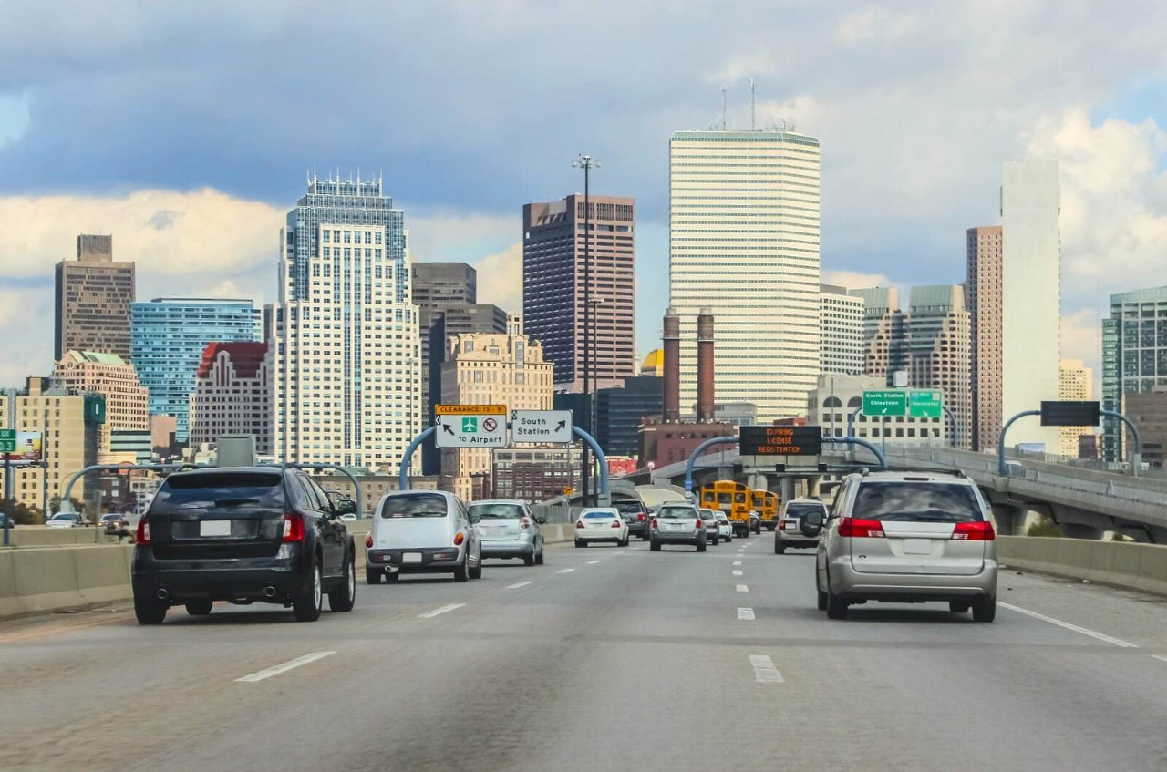 Cars driving on highway toward Chicago skyline with airport sign visible during vehicle data access law debate