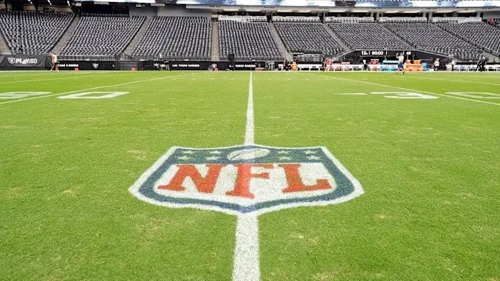 NFL logo at center field in professional stadium with empty bleachers during Super Bowl 59 season