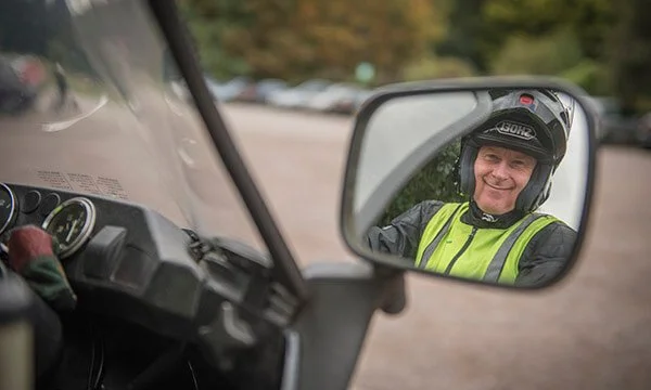 motorcyclist looking at mirror