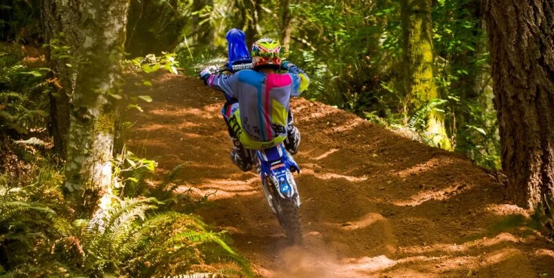 dirt bike wheelie in the woods
