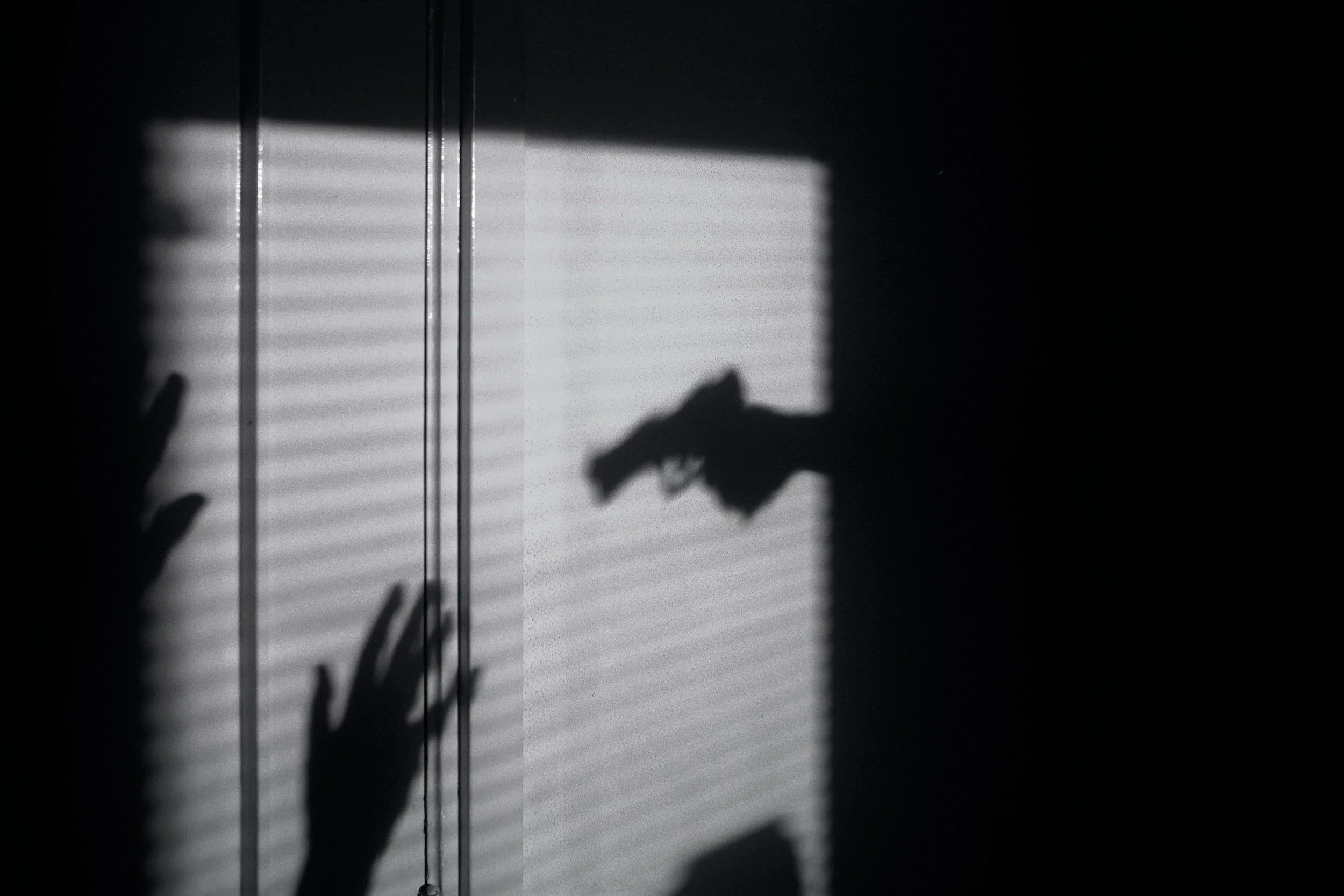 silhouette of held at gunpoint