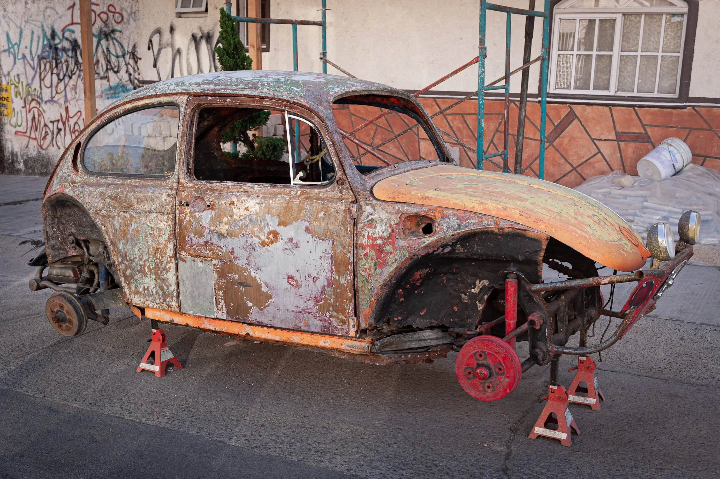 rusty old car without wheels