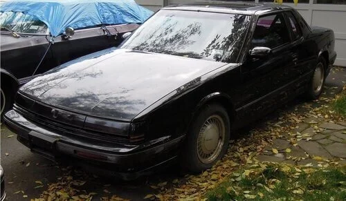 junk car parked in driveway