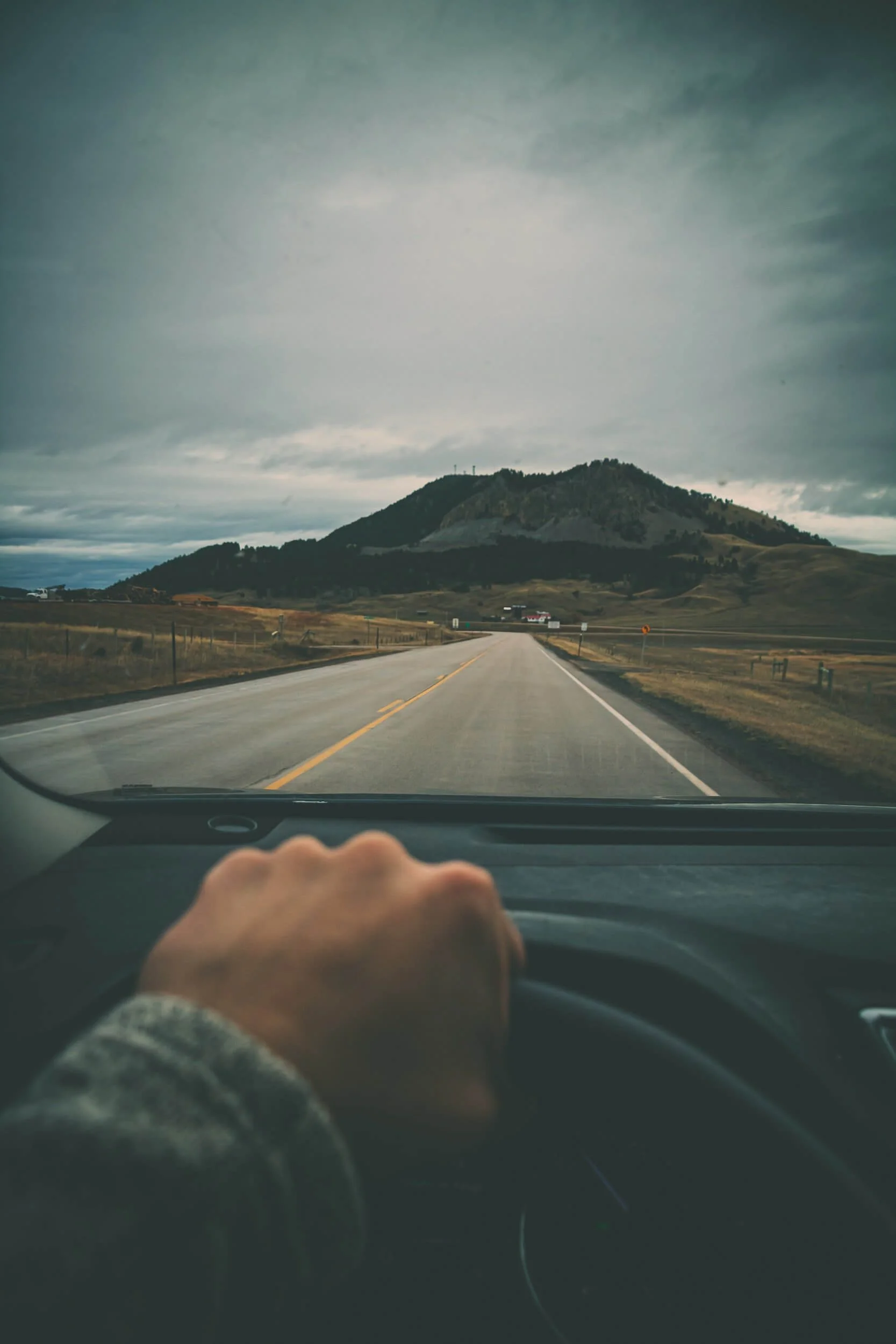 person driving a car on a road