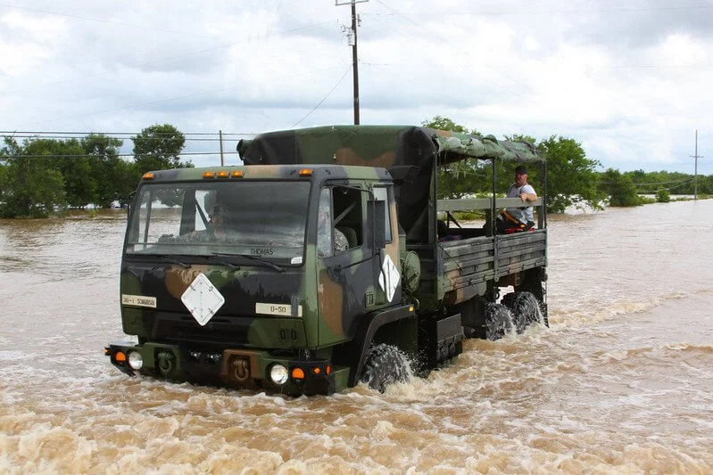 army truck driving through water