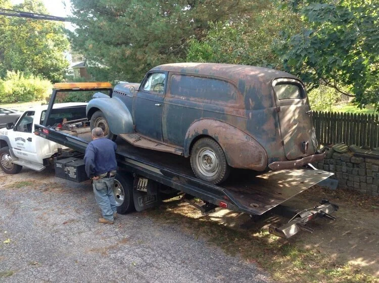 abandoned old car towed