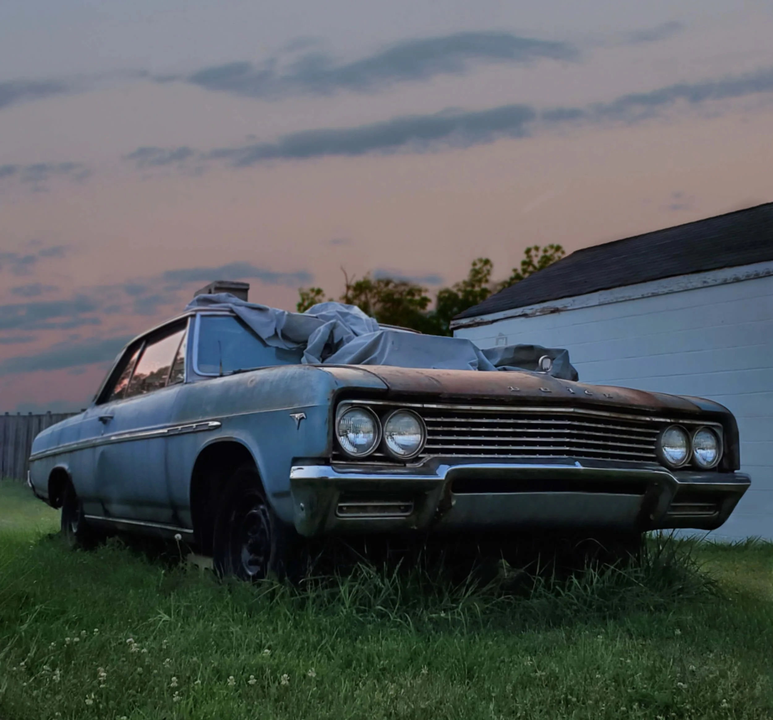old rusty car parked on grass field