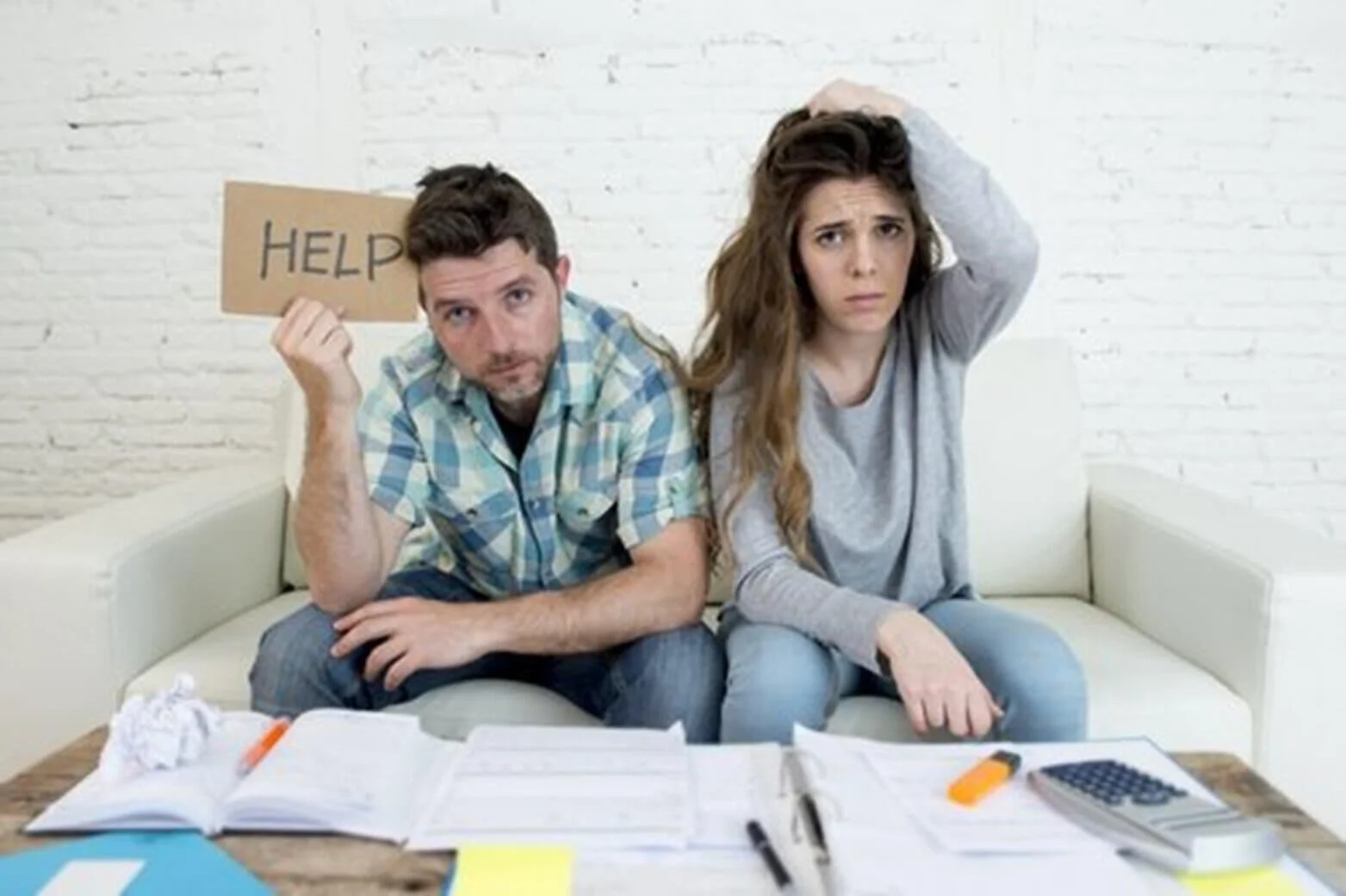 upset man and woman with help sign