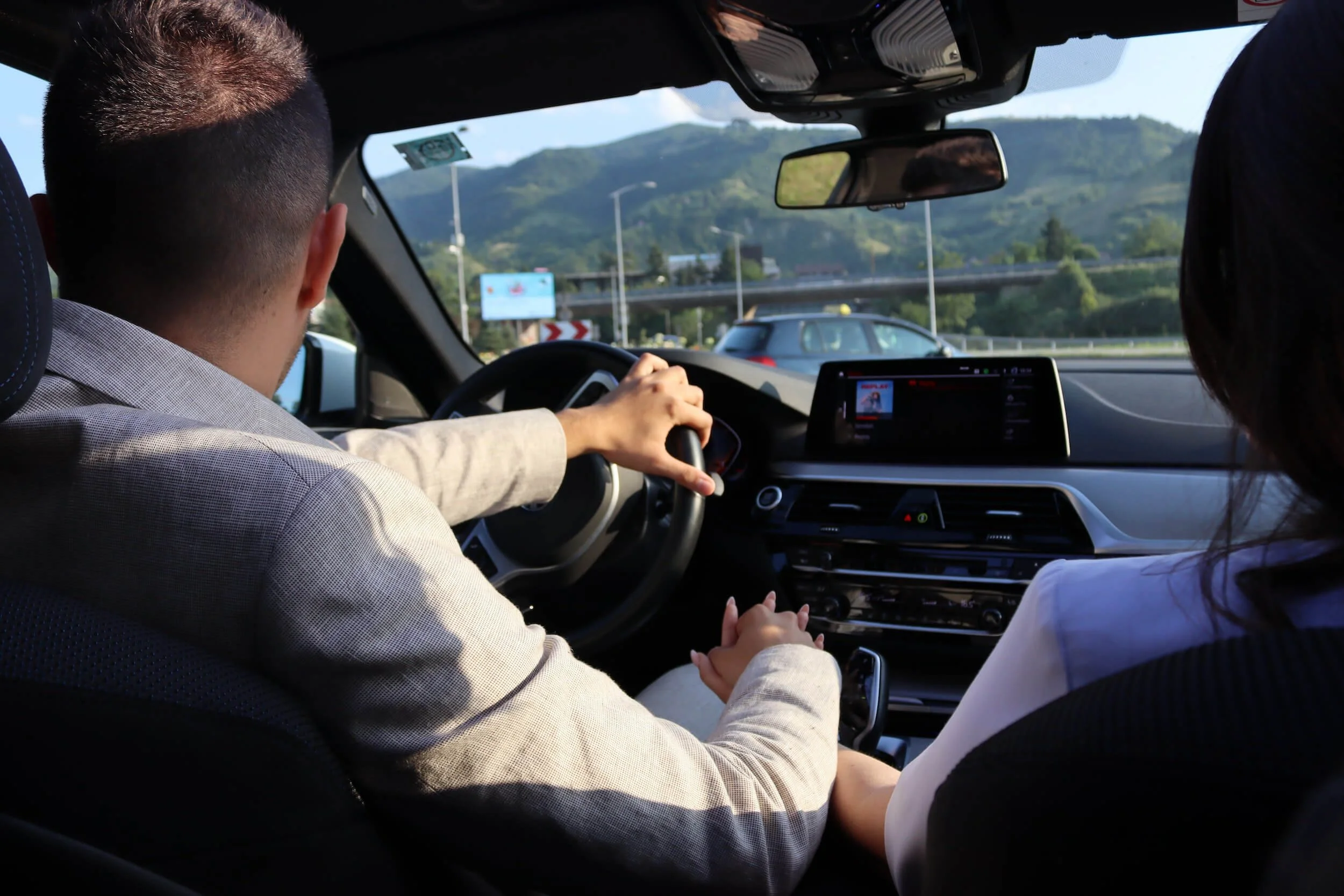 a man and a woman driving car