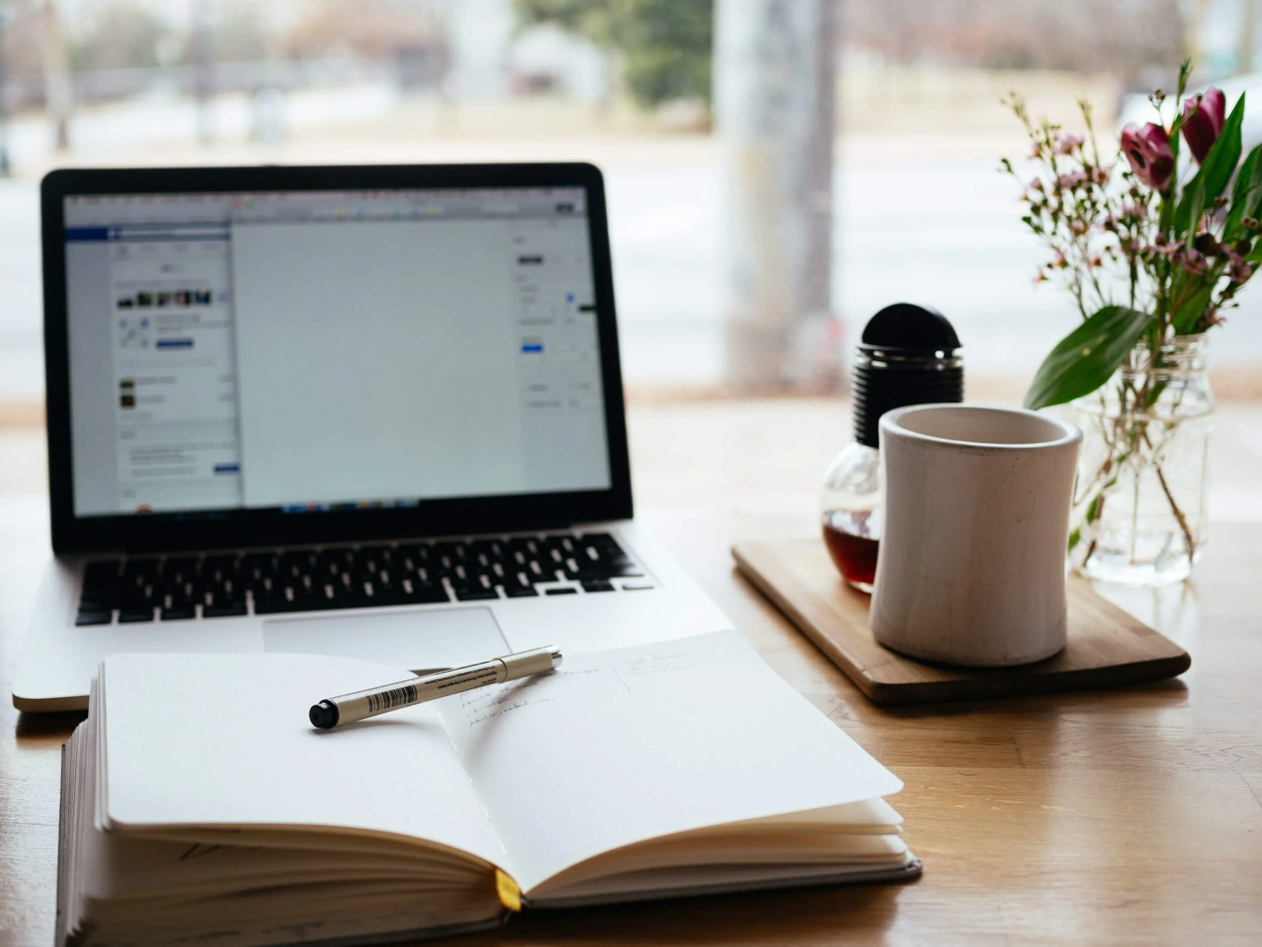 open note book and laptop on desk